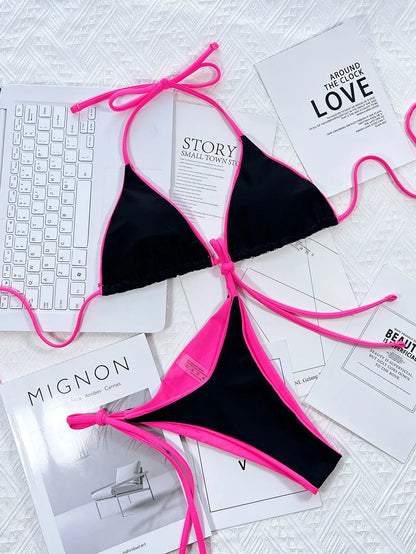 Un bikini Maillot de Bain 2 Pièces rose vif avec des liens à nouer disposés sur une surface blanche aux côtés de magazines de mode chics en noir et blanc et d'un clavier blanc, suggérant un mélange élégant de thèmes de travail, de mode et de loisirs par BREEZE BEEZ.