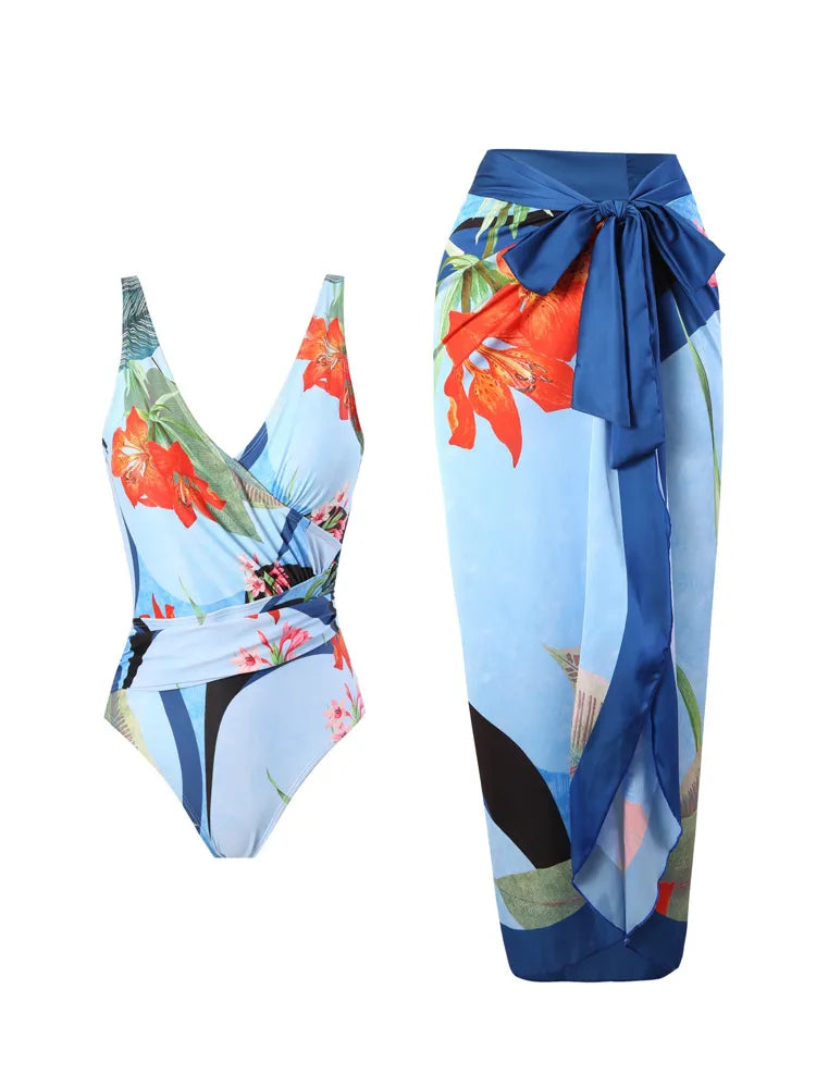 Maillot de bain femme BREEZE BEEZ floral coloré unique associé à un paréo bleu assorti avec un nœud papillon à la taille.